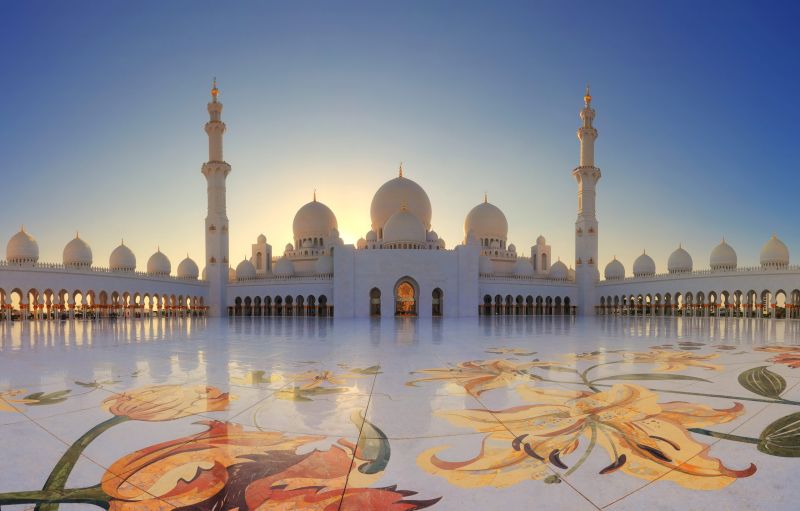 Sheikh Zayed Grand Mosque in Abu Dhabi with white domes, marble courtyards, and reflecting pools.